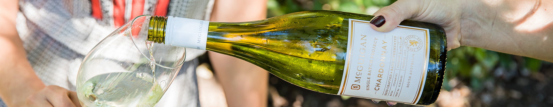 bottle of wine pouring into another